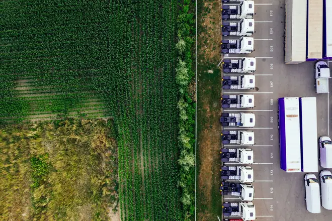 Vue aérienne de poids lourds alignés sur un parc en bordure de champ